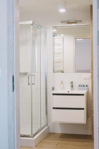 a bathroom with a sink and a glass shower at Motel Witnica in Witnica +17 photos