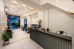 an office lobby with a desk and chairs at Queen Cafe Hostel in Hanoi