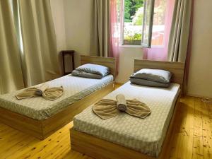 two beds with bows on them in a room at Апартамент ''Габрува'' in Gabrovo
