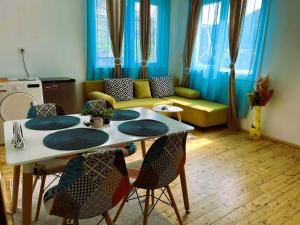 a living room with a table and chairs and a couch at Апартамент ''Габрува'' in Gabrovo