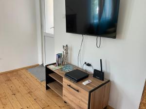 a living room with a tv on a wall at Апартамент ''Габрува'' in Gabrovo