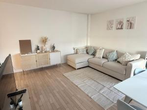 a living room with a couch and a table at Cozy Suite La Défense in Nanterre