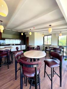 a restaurant with tables and chairs in a room at Casa Amarilla Hotel in Dona Paula