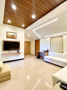 a large living room with a large flat screen tv at Casa Amarilla Hotel in Dona Paula