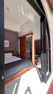 a bedroom with a bed and a large window at Arrum Villa in Ungasan