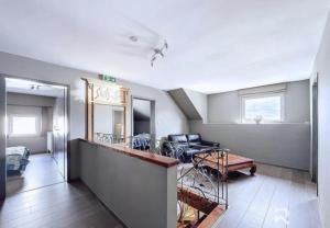 a living room with a staircase and a living room at Zur alten schule in Amblève