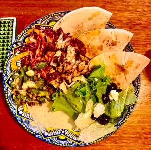 a plate of food with a salad on a table at Easy Tiger - M'Pai Bay Beach, Koh Rong Sanloem in Koh Rong Sanloem