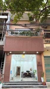 a building with a red awning and a patio at Gasu home in Ninh Binh