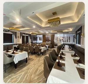 a restaurant with tables and chairs in a room at YU Turn Celebrations in Greater Noida