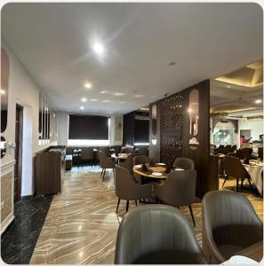 a restaurant with tables and chairs and a television at YU Turn Celebrations in Greater Noida