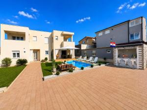 a house with a patio and a swimming pool at Mare Nostrum Suite in Vir