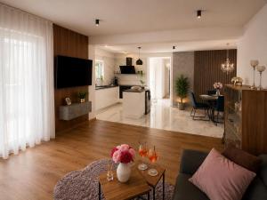 a living room with a couch and a table with flowers at Mare Nostrum Suite in Vir