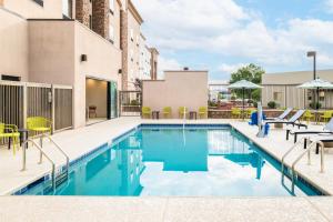 a pool at a hotel with chairs and umbrellas at Hampton Inn & Suites Prescott Valley in Prescott Valley
