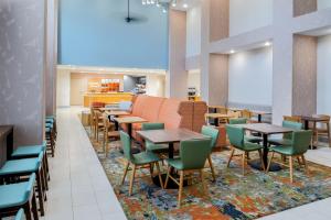 a dining room with tables and chairs on a rug at Hampton Inn & Suites Prescott Valley in Prescott Valley