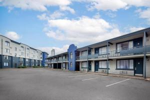 a row of apartment buildings with a parking lot at Quality Inn & Suites in Niagara Falls