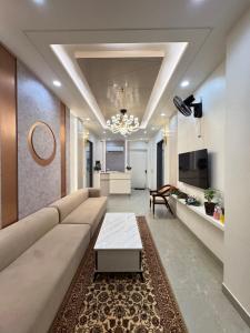 a living room with a couch and a coffee table at Hotel RajKailash in Jaipur