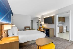a hotel room with a large bed and a kitchen at Comfort Inn Douglasville - Atlanta West in Douglasville