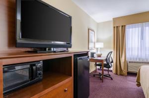 a hotel room with a large flat screen tv at Quality Inn & Suites Colby in Colby