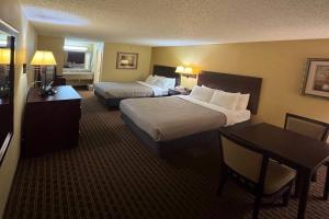 a hotel room with two beds and a desk at Quality Inn Franklin South in Franklin +17 photos