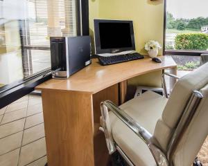 a desk with a computer on it with a chair at Quality Inn Franklin South in Franklin