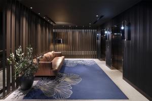a lobby with a couch and a blue carpet at West Hotel Sydney, Curio Collection by Hilton in Sydney