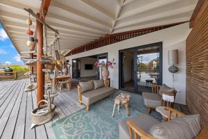 a living room with a couch and chairs on a deck at El Patrón, the villa in Jan Thiel