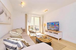 a living room with a couch and a tv at Island Villa Alba with Terrace & Grill - Happy Rentals in Mali Lošinj