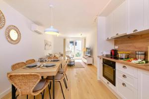 a kitchen with a table and chairs in a room at Island Villa Alba with Terrace & Grill - Happy Rentals in Mali Lošinj