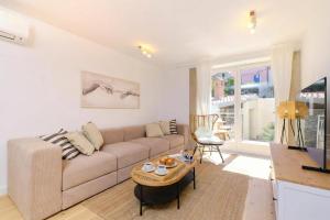 a living room with a couch and a table at Island Villa Alba with Terrace & Grill - Happy Rentals in Mali Lošinj