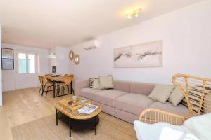 a living room with a couch and a table at Island Villa Alba with Terrace & Grill - Happy Rentals in Mali Lošinj
