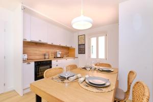 a dining room with a table and chairs and a kitchen at Island Villa Alba with Terrace & Grill - Happy Rentals in Mali Lošinj +27 photos
