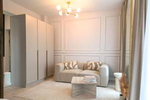 a living room with a couch and a table at Luxury Studio Chiajna in Roşu