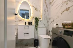 a bathroom with a toilet and a sink and a mirror at Luxury Studio Chiajna in Roşu