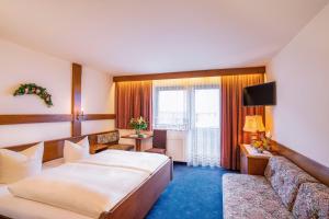 Postel nebo postele na pokoji v ubytování Sporthotel Pechtl
