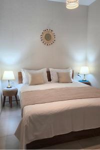 a bedroom with a large bed with two lamps at Weekend Borjomi in Borjomi