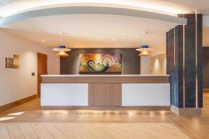 a lobby with a bar with a tv on the wall at Cambria Hotel Pigeon Forge in Pigeon Forge +63 photos