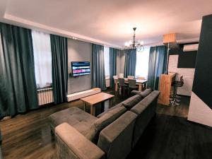 a living room with a couch and a dining room at Fortuna Gabala Boutique Hotel & Restaurant in Gabala