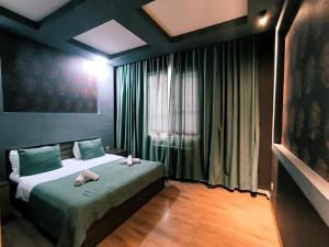 a bedroom with a bed with two towels on it at Fortuna Gabala Boutique Hotel & Restaurant in Gabala +7 photos