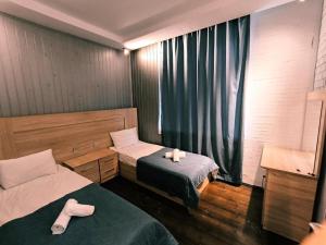 a room with two beds and a window with towels at Fortuna Gabala Boutique Hotel & Restaurant in Gabala