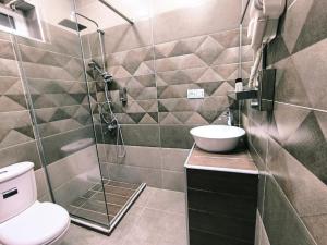 a bathroom with a shower and a toilet and a sink at Fortuna Gabala Boutique Hotel & Restaurant in Gabala