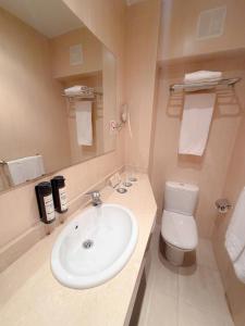 a bathroom with a white sink and a toilet at Hotel Faranda Alisas Santander, Ascend Hotel Collection in Santander