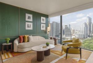 a living room with a couch and a large window at Andaz One Bangkok, by Hyatt in Bangkok