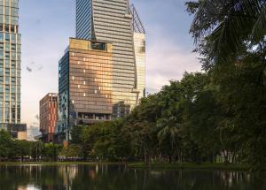 a city skyline with tall buildings and a lake at Andaz One Bangkok, by Hyatt in Bangkok