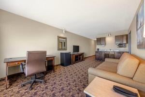 a living room with a couch and a desk at Newport Oceanfront Inn in Newport