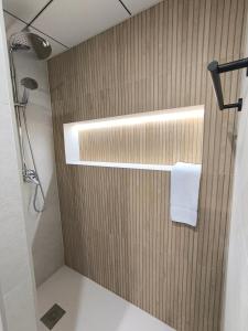a bathroom with a shower with a wooden wall at Las Casillas de Laujar in Laujar de Andarax +72 photos