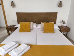 a large white bed with two pillows on it at Las Casillas de Laujar in Laujar de Andarax
