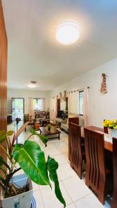 a living room with a couch and a dining room at MacCreek in Macrohon