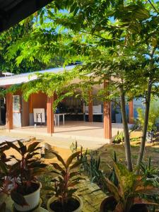 a courtyard with a building with trees and plants at MacCreek in Macrohon