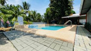 a swimming pool in front of a house at MacCreek in Macrohon +14 photos