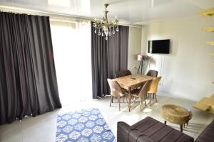 a living room with a dining room table and a couch at Weekend Borjomi in Borjomi